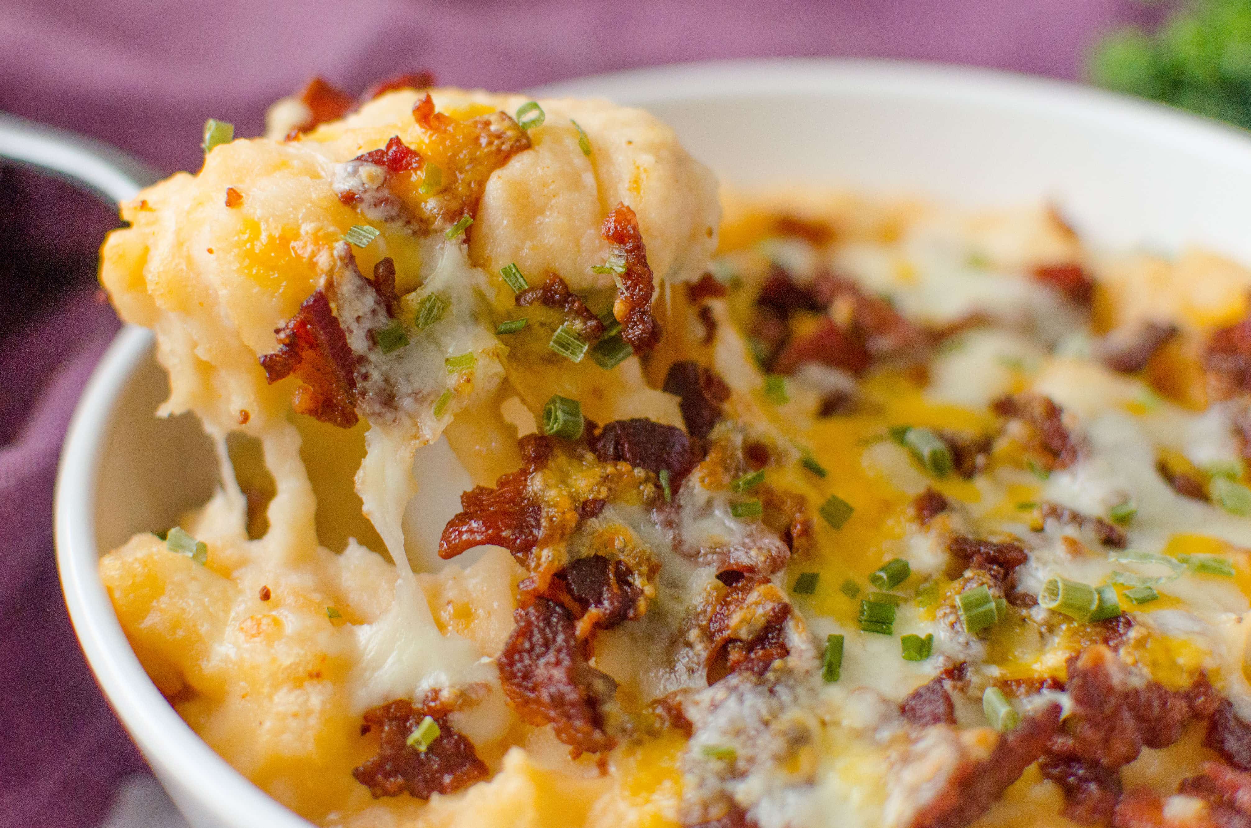 Barbecue Bacon Potato Casserole is a smokey twist on the classic twice baked potato. The creamy mashed potatoes are hit with a some barbecue sauce  to give the potatoes a whole new dimension. Bacon and cheese are broiled on the top until it reaches melty perfection