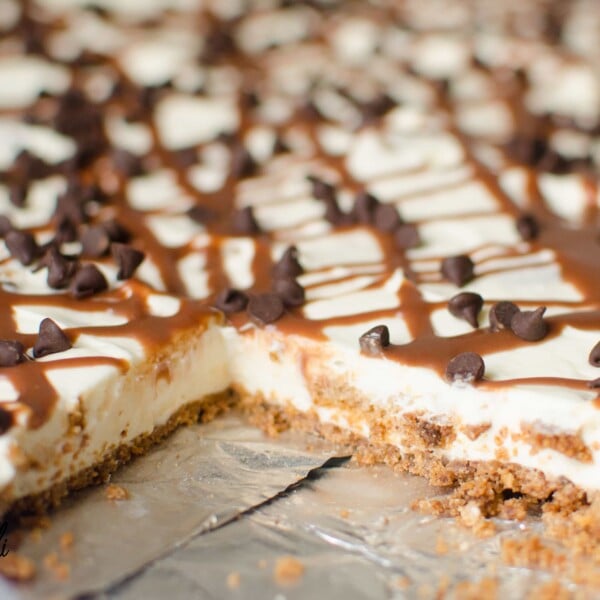 No Bake Chocolate Chip Cookie Slab Cheesecake is a sweet and creamy no bake cheesecake loaded with chocolate chip cookie pieces on top of a simple cookie crust to make this a crowd pleasing dessert. 
