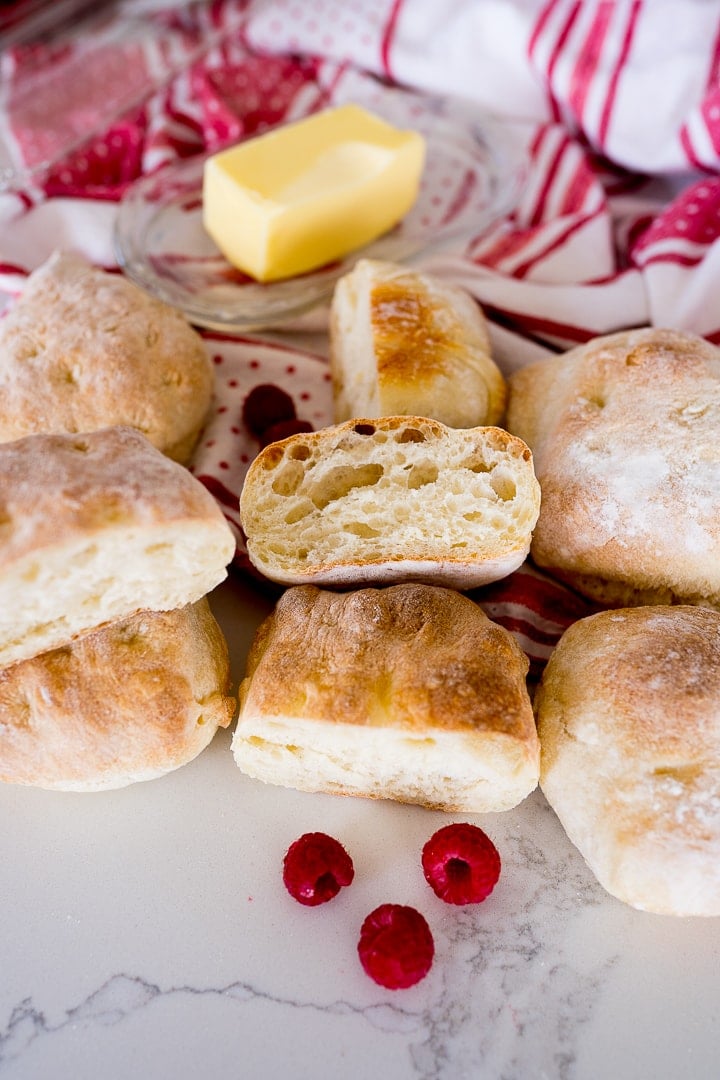 ciabatta rolls cut in half, with butter and raspberries