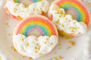 Slice ‘n Bake Rainbow Sugar Cookies are made from a soft vanilla sugar cookie dough, rolled in layers, then sliced and baked. The cookies are finished off with vanilla butter cream clouds.