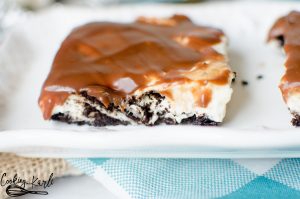 No Bake Oreo Cheesecake Slab is a crowd feeder and crowd pleaser!! Oreo crust, homemade no bake cheesecake with Oreo chunks in the middle with a delicious chocolate ganache topping to finish it off! This is sure to be a party favorite!