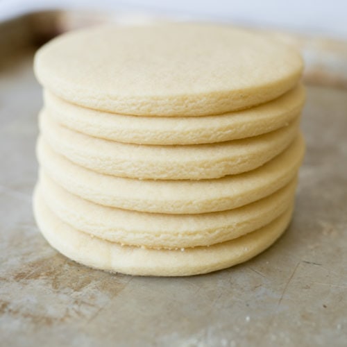 roll and cut sugar cookies, baked and stacked for photo