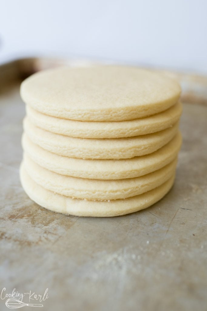 roll and cut sugar cookies, baked and stacked for photo