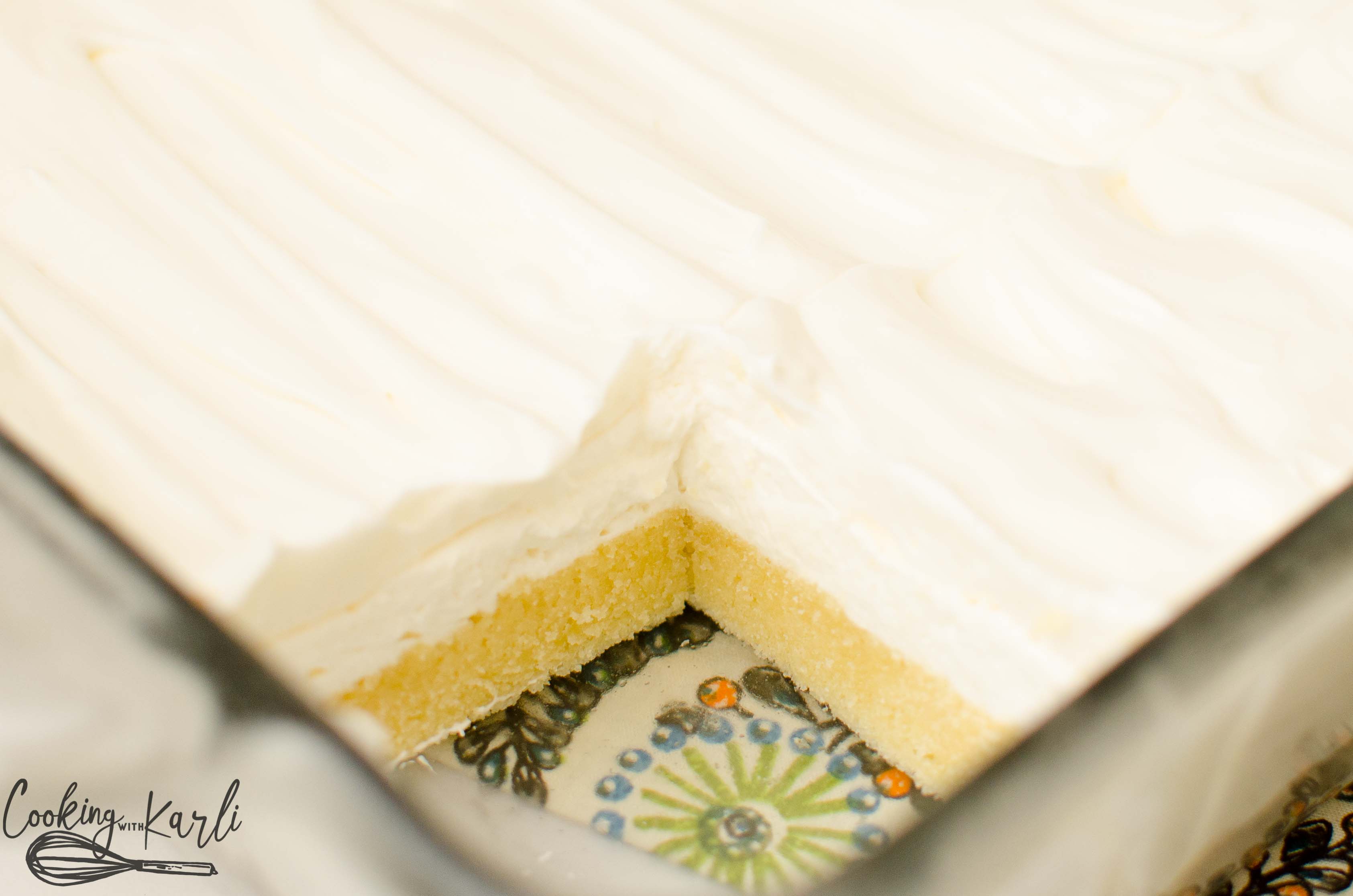 With a sugar cookie crust, cream cheese layer and a vanilla cool whip layer, this lush cake is sure to be a winner!