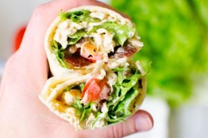 A great healthy lunch option is this BLT Chicken Wrap loaded with lettuce, bacon, tomatoes, and chicken.
