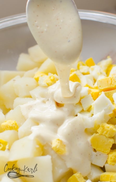 The dressing for this potato salad is made up of miracle whip, mustard, milk, and a few other ingredients.
