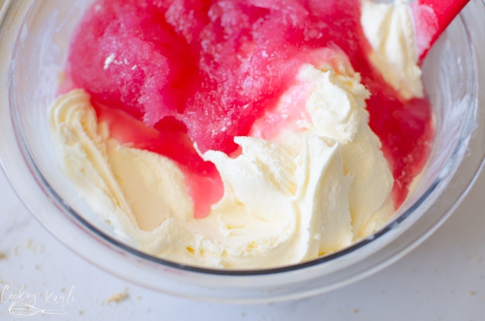 vanilla ice cream and raspberry lemonade concentrate in a bowl before being mixed together.
