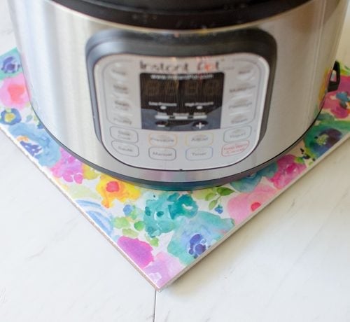 DIY hot plate made from a tile and scrapbook paper makes the perfect Instant Pot stand.