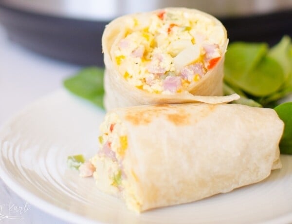 Instant Pot Breakfast Burritos are an easy way to make breakfast burritos for a crowd! Simple ingredients like frozen O'Brien Hash browns, Diced Ham, and Eggs are thrown in the Instant Pot to cook without babysitting!  |Cooking with Karli| #breakfast #Instantpot #pressurecooker #breakfastburrito #hashbrowns #eggs #recipe