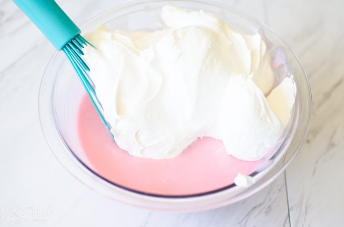 The pink lemonade concentrate and sweetened condensed milk mixture before it is folded into the cool whip.
