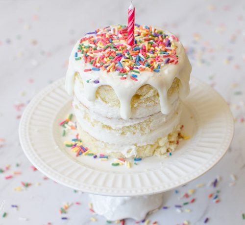 Small, easy smash cake for a first birthday covered in sprinkles.