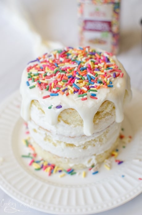 Smash cake covered with frosting and sprinkles.