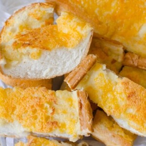 Garlic cheese bread is made from french bread, butter, garlic and cheese.