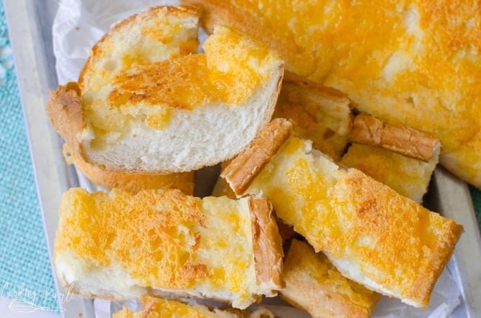 Garlic cheese bread is made from french bread, butter, garlic and cheese.