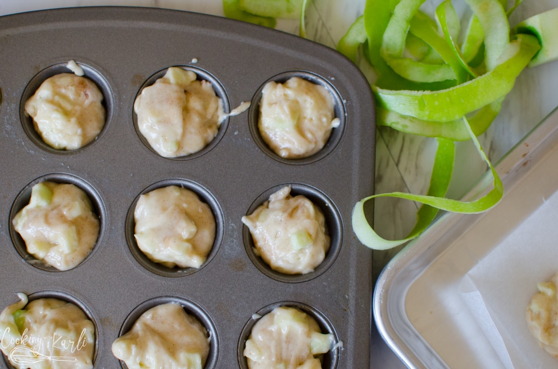 muffin batter scooped into muffin tins.