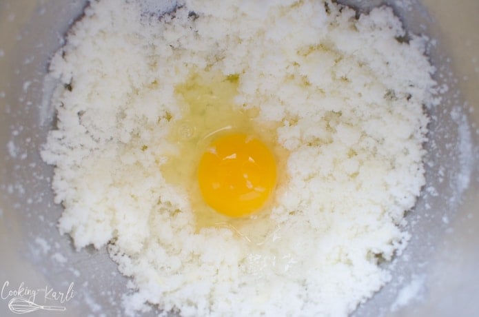Butter, sugar and an egg are combined.