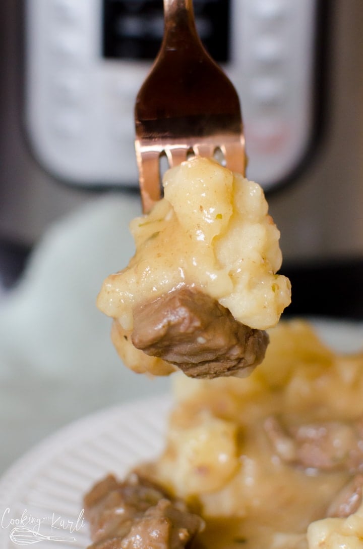 mashed potatoes with steak meat and gravy.
