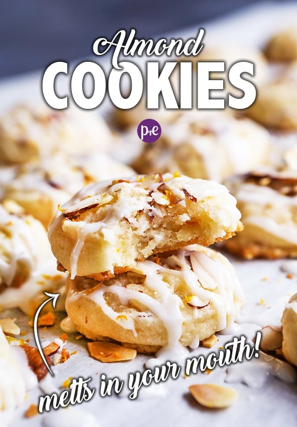 These Almond Cookies are melt-in-your-mouth delicious and super easy to make! The cookies have a chewy texture with crunchy bits of almond. They are topped with an almond glaze and a touch of orange zest that will leave you wanting more (and more and more)! #almondcookie #christmascookie #cookie #recipe