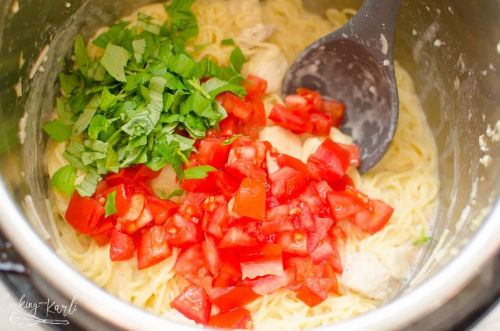 tomatoes and basil added to the pasta dish
