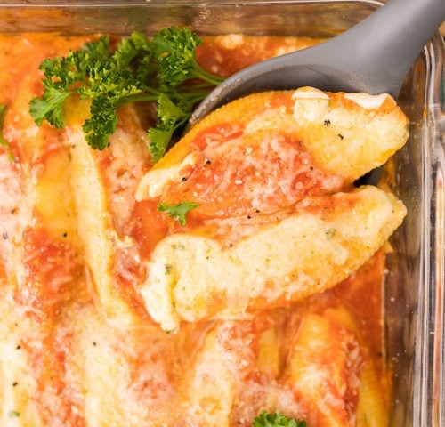 stuffed shells, cooked and being served.