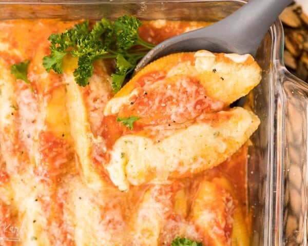 stuffed shells, cooked and being served.