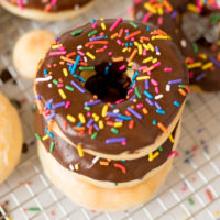 homemade donuts, recipe, finished and served. Chocolate icing with sprinkles.