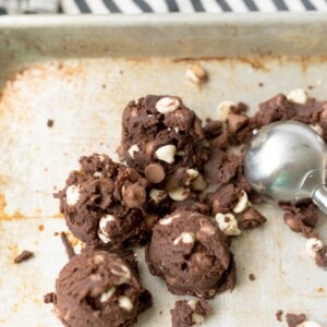 chocolate cookie dough with white chocolate chips on a cookie sheet
