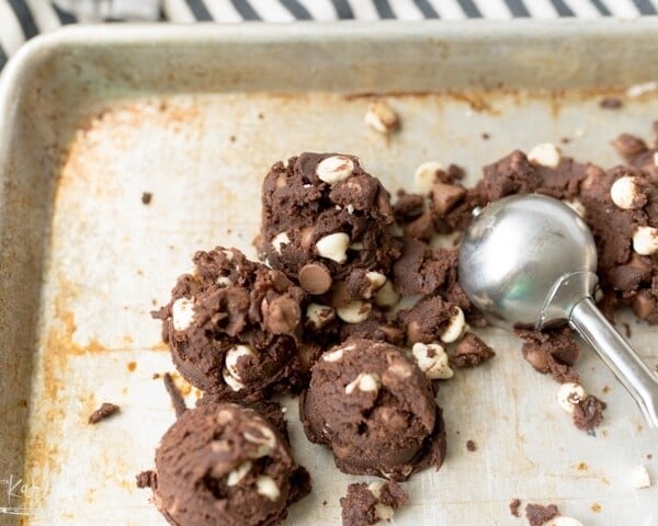 chocolate cookie dough with white chocolate chips on a cookie sheet