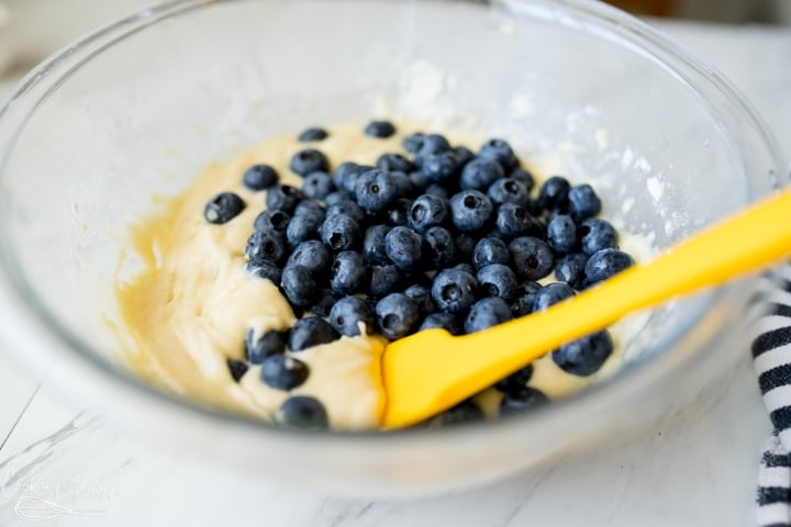 blueberries being added to the batter for the blueberry fritters