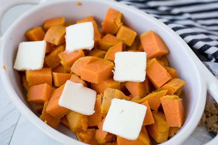 sweet potatoes in a dish with butter for a sweet potato casserole