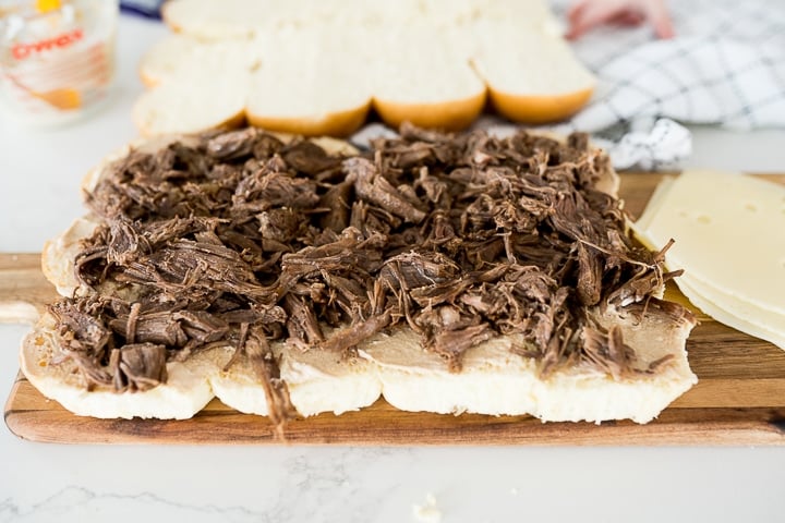 Cream cheese spread and roast beef on Hawaiian rolls for French dip sliders