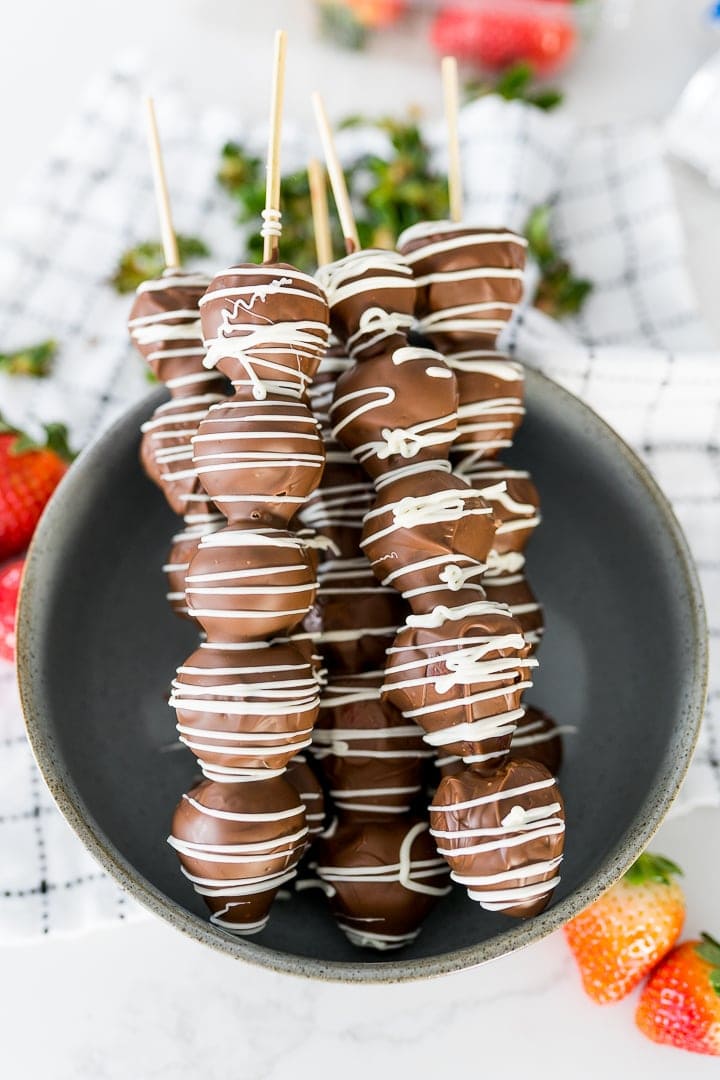 Chocolate covered strawberries on wooden skewers