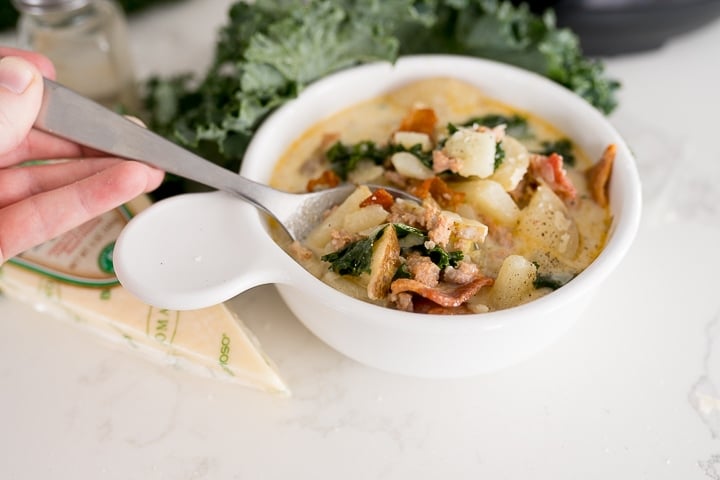 Instant Pot zuppa toscana soup, being eaten.