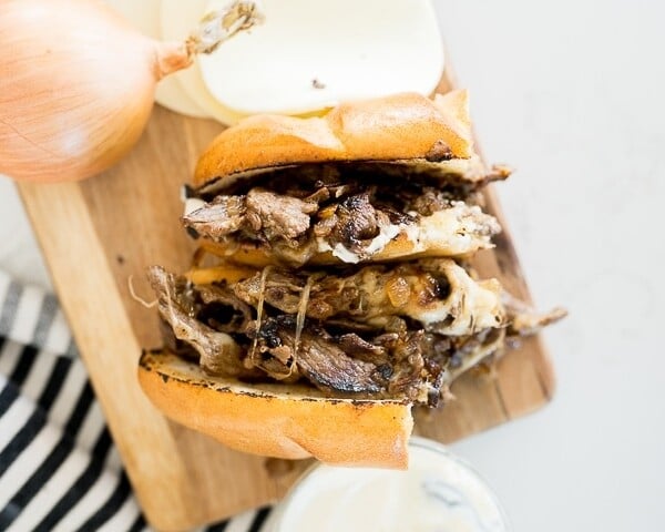 Philly cheesesteak sandwich cut in half and served