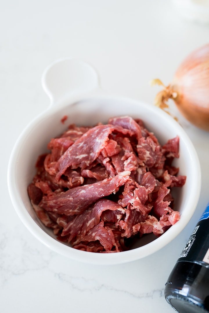 thinly sliced steak for Philly cheesesteak recipe