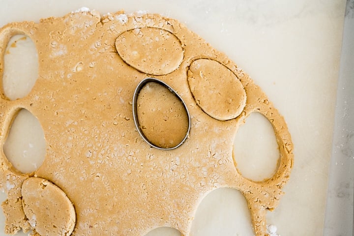egg cookie cutter cutting the peanut butter dough into shape