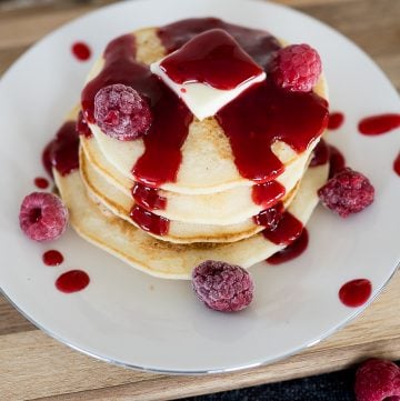 raspberry syrup on a stack of pancakes