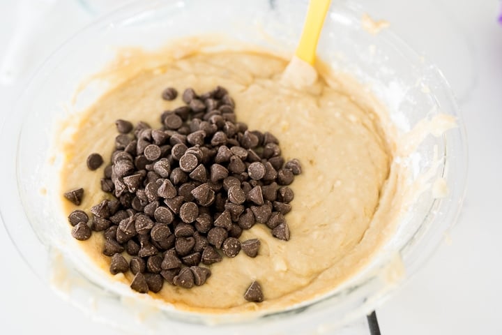 banana muffin batter with chocolate chips before mixing them together.