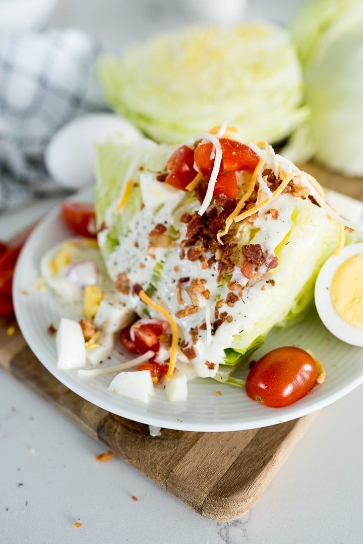 wedge salad, plated and topped with toppings