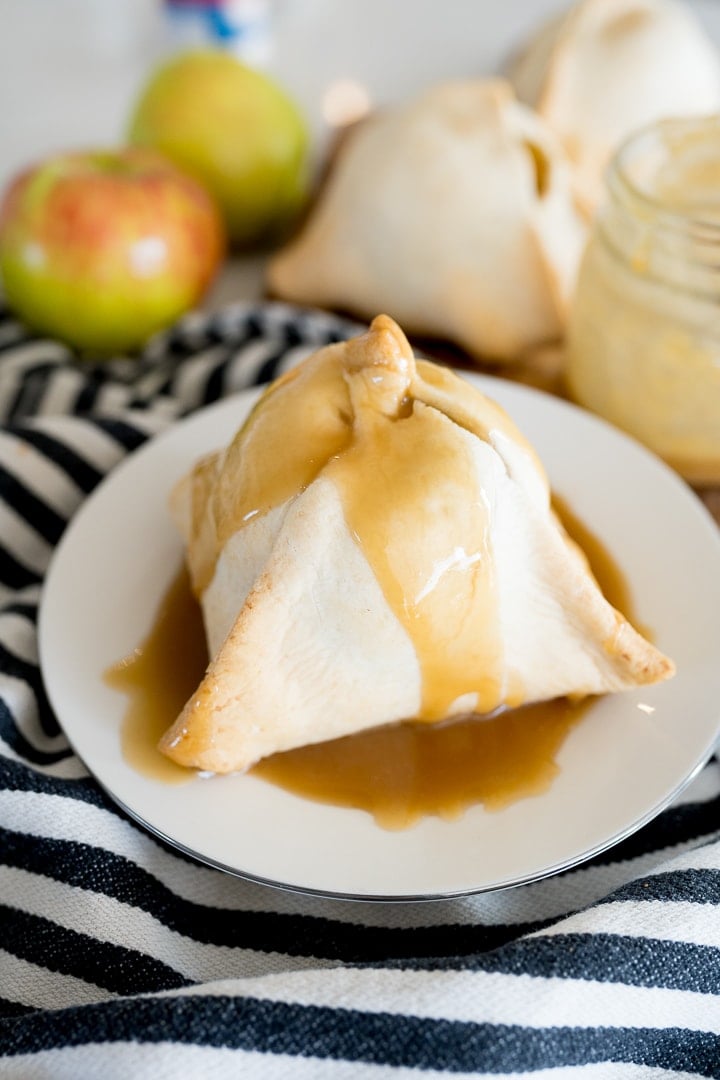 apple dumpling drizzled with caramel on a white plate
