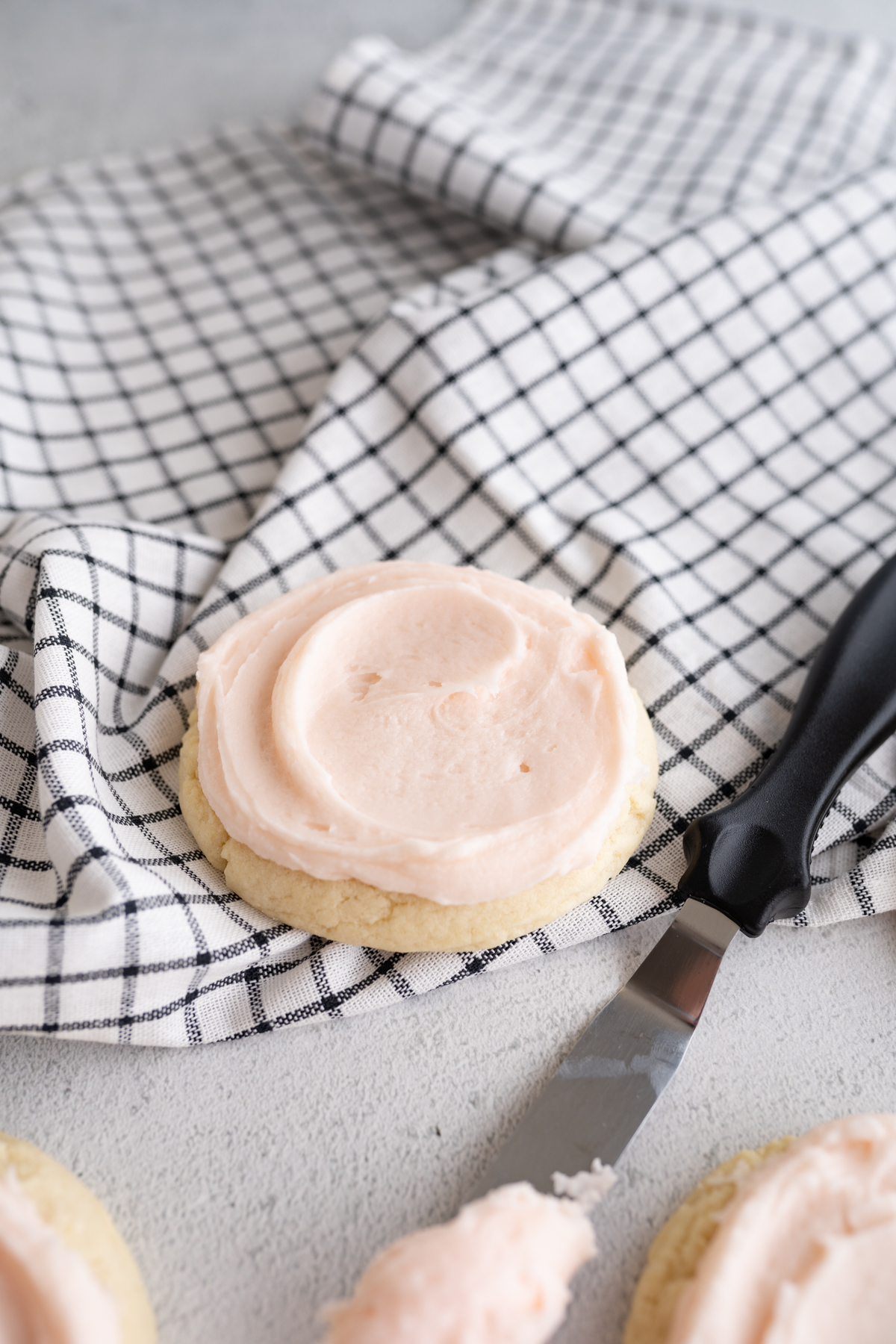crumbl sugar cookies on a plaid napkin.