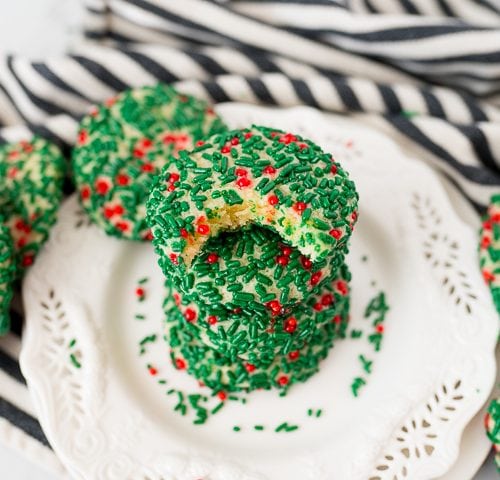 sprinkle Christmas cookies, baked and stacked onto a plate.