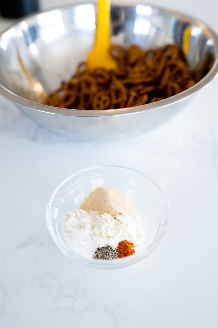 seasonings in a small bowl in front of pretzels