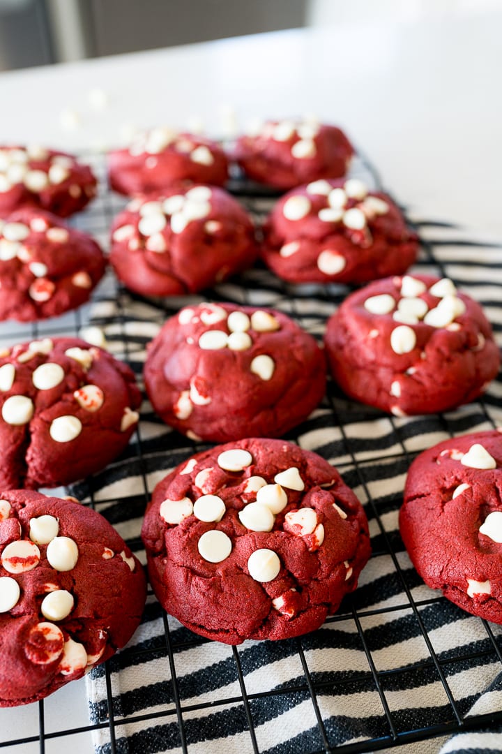 red velvet cookies with white chocolate chips on a cooling rack