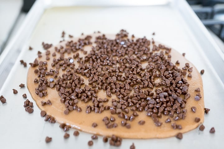 toffee on a pan, with chocolate chips on top