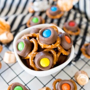 pretzels with rolls and m&m's on top in a small bowl