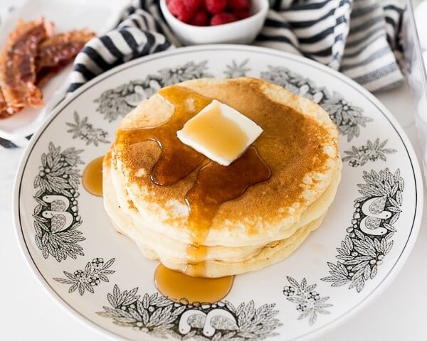 buttermilk pancakes stacked with maple syrup