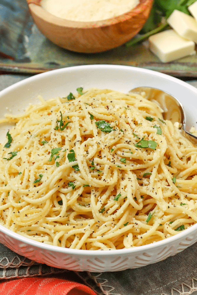 garlic parmesan noodles in a white bowl