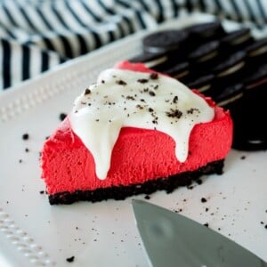 red velvet cheesecake slice with cream cheese glaze