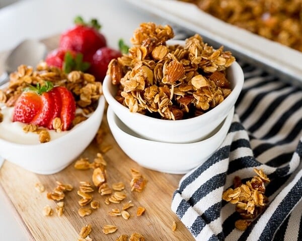 Homemade granola in a white bowl with strawberries